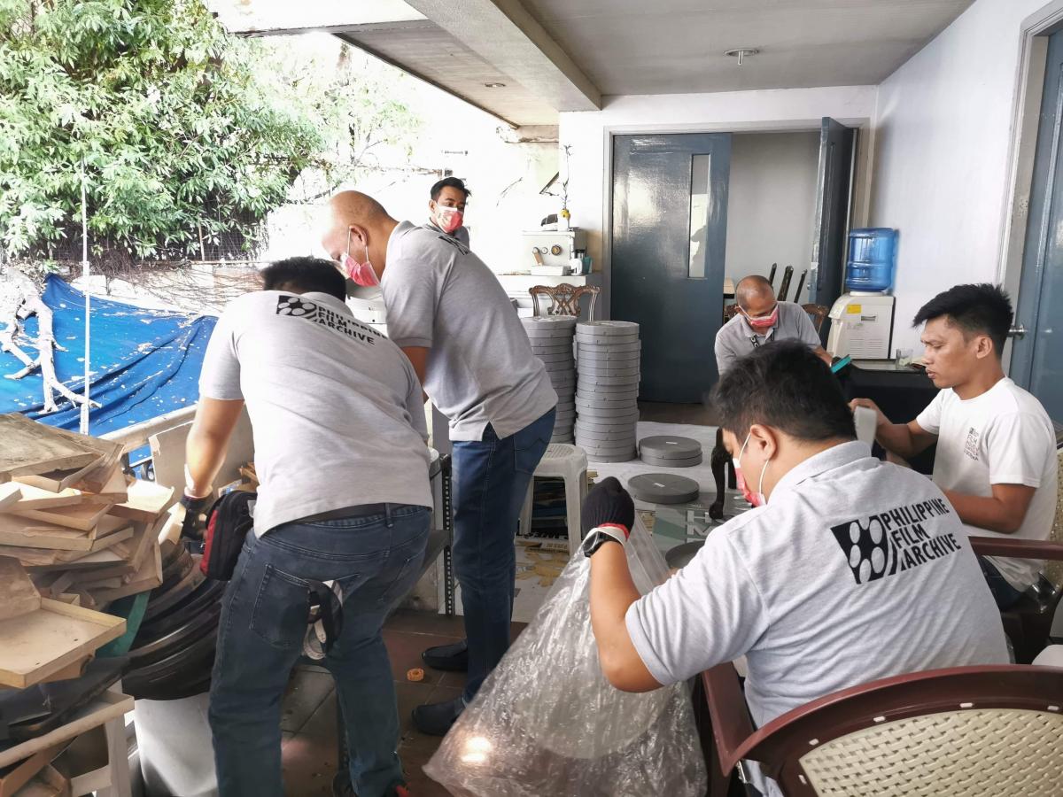 The PFA team transfers film reels from old to new cans